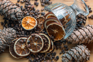Christmas still life, brown, pine nuts and cones, garlands, dried oranges