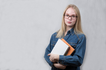 Smart teenage girl with books on white background.