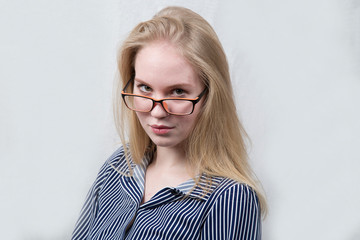 Beautiful blonde girl on grey background. Close up.