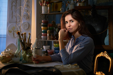 In the creative workshop young talented woman is working on her new project.