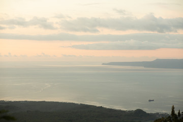 Beautiful top view with sun rays from under the clouds. Magnificent and tropical landscape in Bali, Indonesia.