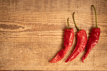 Red peppers on the old wooden background. Dried chilly peppers is a food of Asian. Spicy food concept.