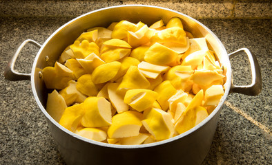Peeled and sliced quinces on a iron pan ready to cook
