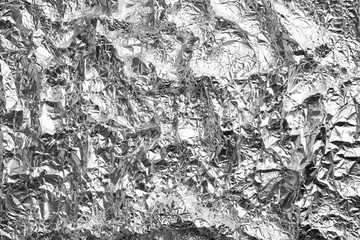 Fototapeta na wymiar Crumpled silver foil as background, closeup view