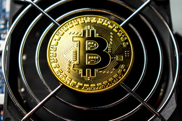 Bitcoin coin is on a computer cooler.