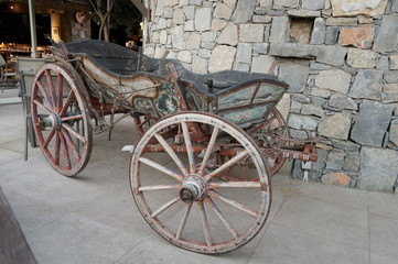 Fototapeta na wymiar an old wooden cart against a stone wall