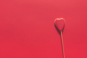 Fototapeta premium Heart shaped cookies with red icing on a red background, love concept, valentines day, wedding, flat lay monochrome