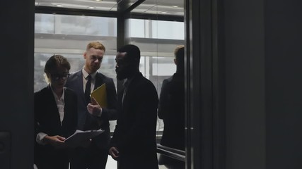 Lawyers walking out of lift