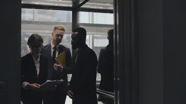 Lawyers walking out of lift