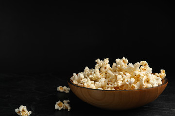 Tasty fresh pop corn on black table