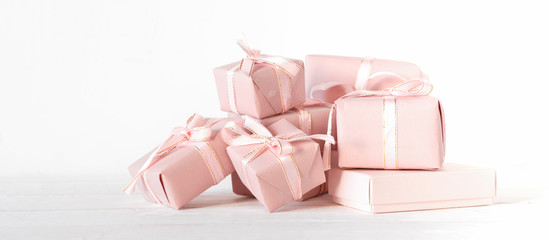 Valentine's Day. Gifts in pink boxes and golden hearts on a light background, festive background, wedding, birthday