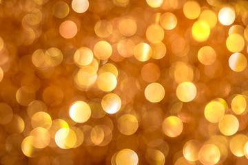 Festive golden and orange background with bright bokeh_