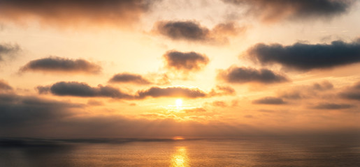 Naklejka na ściany i meble Golden sunset over the sea