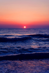 Beautiful sunrise on the sea coast in a storm