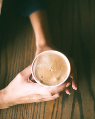 Drinking latte coffee in a coffee shop cafe