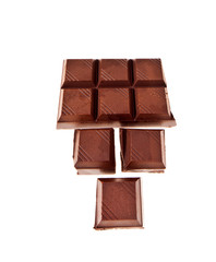 Chopped chocolate bar isolated on white background. Top view.