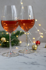 Orange wine is poured into two glasses. Celebratory drink. Family celebration.