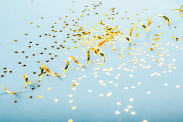 Golden stars on blure background. Flat lay, top view.