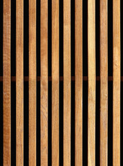 Seamless texture of wooden decorative battens placed vertically on facade of building. New York....