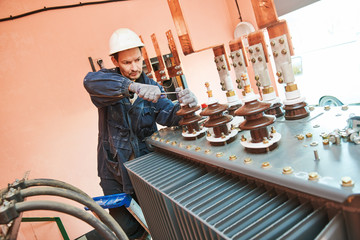 Electrician lineman worker installing power industrial transformer - obrazy, fototapety, plakaty