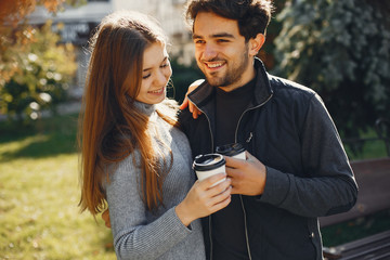 Cute couple in a spring city. Lady with long hair. Man in a black jacket