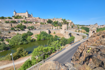 Fototapeta na wymiar Landscape view of the old town of the middle ages city of Toledo and the Alcantara bridge over the Tagus river, Castilla la Mancha, Spain