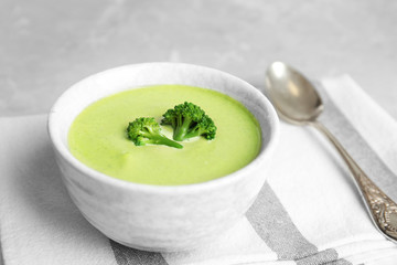 Delicious broccoli cream soup served on table
