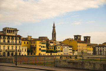 Fototapeta premium View of the historic centre of Florence, Unesco World Heritage Site, from Ponte alle Grazie bridge with Lungarno delle Grazie riverside and the bell tower of Basilica of Santa Croce, Tuscany, Italy