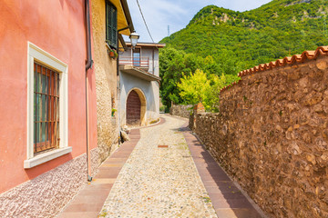 Old village street view, narrow alley, old architexcture and touristic landmark at Renzano near Salo, Italy