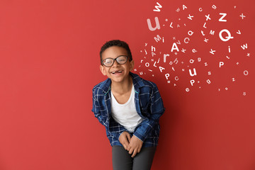 Laughing African-American boy on color background - obrazy, fototapety, plakaty