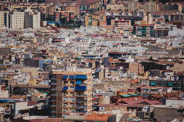 Fototapeta premium Beautiful wide aerial view of Alicante, Valencian Community, Spain with port of Alicante, beach and marina, with mountains and skyline, seen from Santa Barbara Castle on Mount Benacantil, sunny day