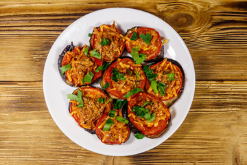Baked eggplants with tomatoes and cheese on wooden table. Top view
