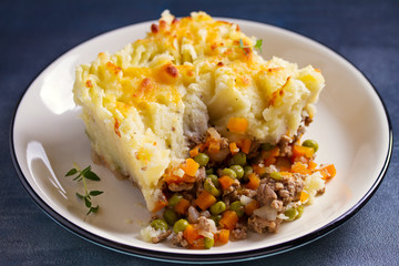 Shepherd's Pie or Cottage Pie on plate, gray backgroud. Horizontal image