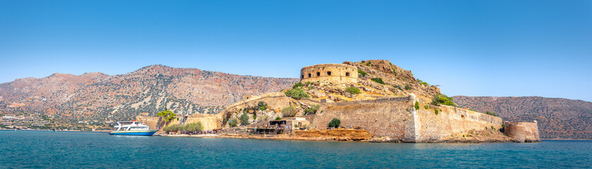 View of the island of Spinalonga with calm sea. Here were isolated lepers, humans with the Hansen's desease, gulf of Elounda, Crete, Greece. 