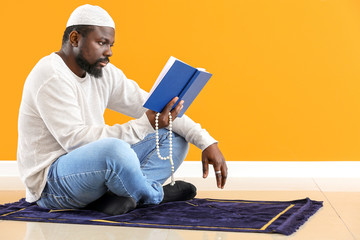 African-American Muslim man praying indoors