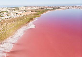 Beautiful aerial wide vibrant summer view of las Salinas de Torrevieja, The Pink Lake Of Torrevieja, pink salt lagoon in Torrevieja, Costa Blanca, province of Alicante, Spain