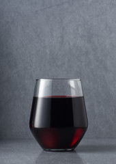 Juice in a glass, on a gray background
