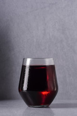 Juice in a glass, on a gray background
