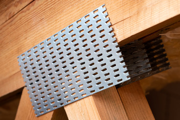 Detail of a truss with galvanized nail plates. - obrazy, fototapety, plakaty