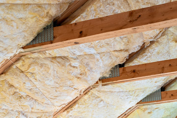 Glass mineral wool insulation in between roof rafters.