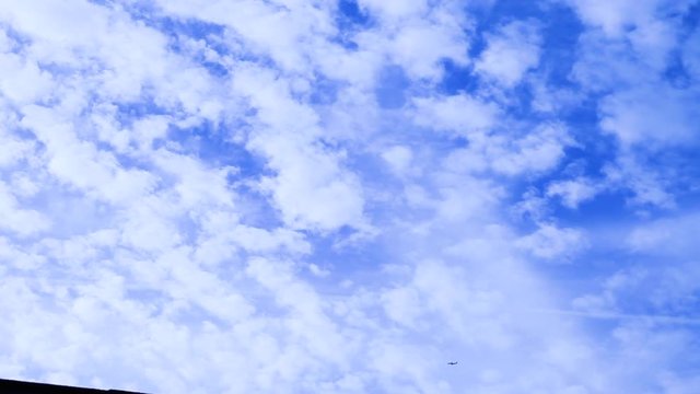 Airplane Flies Low In The Sky, Under Many Layers Of Cloud Seeding And Homomutatus Clouds.The Plane Does Not Leave A Chemtrail But Flies Below The Existing Trails That Have Been Blown Outwards As Cloud