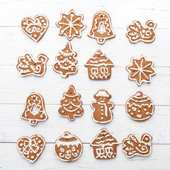 A set of handmade Christmas gingerbread against a background of white boards. A look from above. New Year's concept