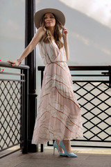 Fashionable woman in summer dress relaxing outdoor