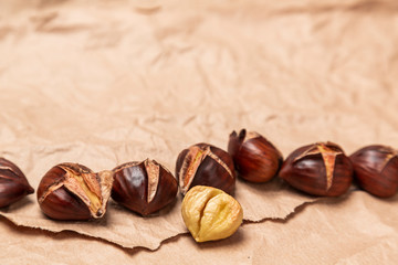 Roasted chestnuts on paper background