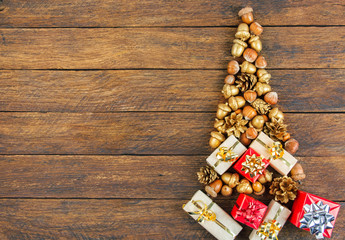 Christmas tree made of golden nuts and acorns. merry christmas and happy new year CARD top view