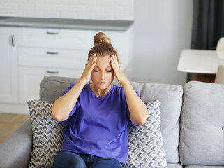 Portrait of young woman suffering from ache.	