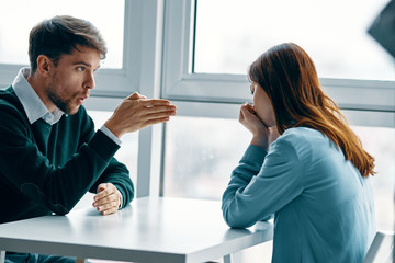 man and woman shaking hands in office