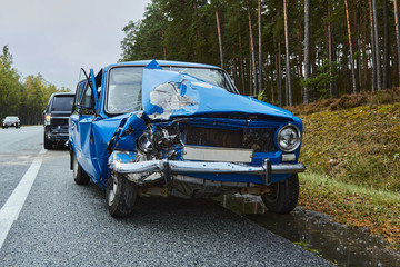 Fototapeta premium damaged old car on the highway at the scene of an accident