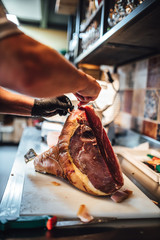Chef cutting aged beef meat in restaurant kitchen