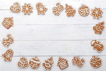 Christmas gingerbread handmade on a white wooden background. A look from above. New Year's concept.